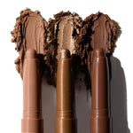 Essential Neutrals ColourPop Shadow Stix set swatched - three creamy eyeshadow sticks in matte taupe, shimmer bronze, and deep chocolate - displayed with smears behind the tips on white to show blendable, long-wear color.