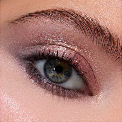 Close-up of a blue-green eye wearing Twilight-inspired Coven Clash Jelly Much Duo, showing shimmery mauve and rose-gold eyeshadow blended across the lid and crease for a soft, metallic glam look.